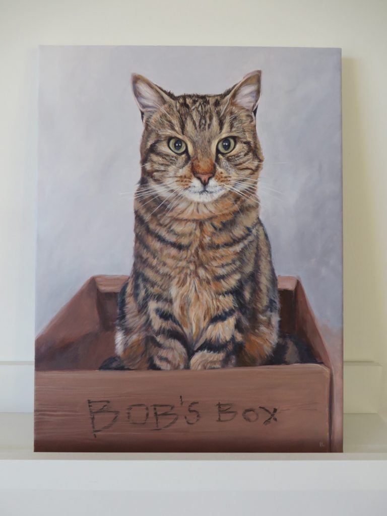 acrylic painting of a tabby cat sitting in a cardboard box