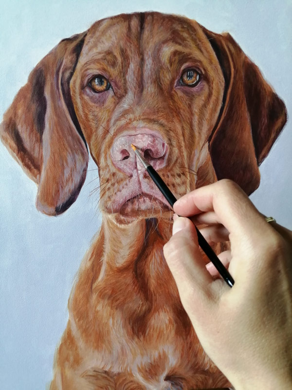 finishing details on a dog portrait painting