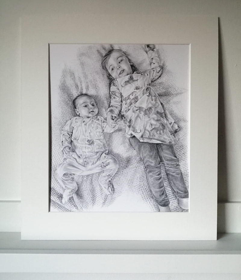 mounted portrait drawing of two children