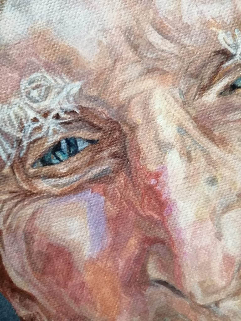 close up detail of the man's eye, nose and cheek in a painting