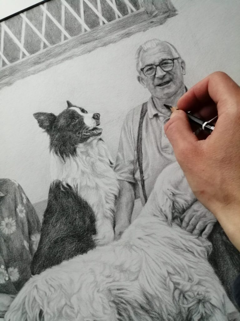 working on a portrait of a man smiling