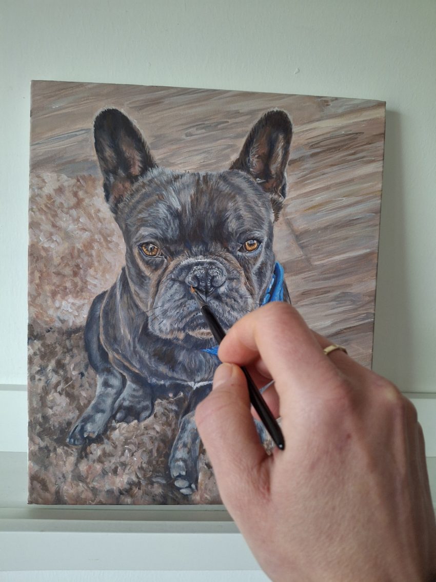 adding detail to a dog portrait painting with a round brush