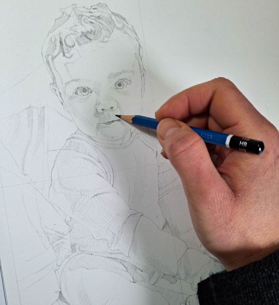 sketching a baby boy portrait with graphite pencil on paper