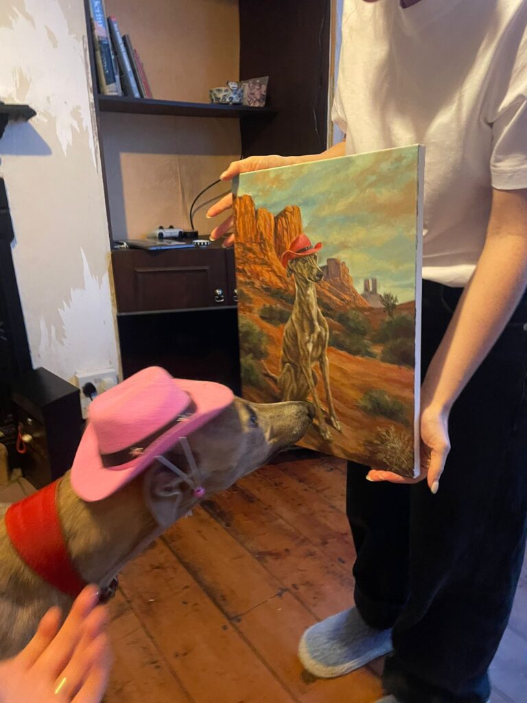 whippet admiring his portrait painting canvas