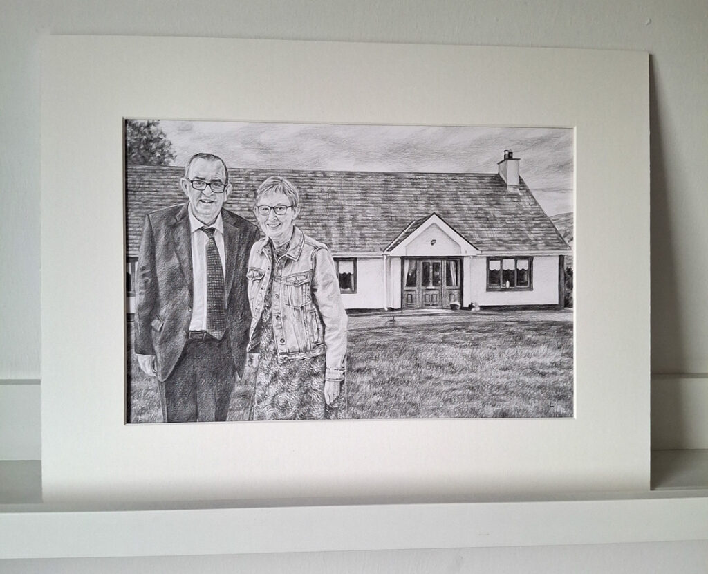 mounted pencil drawing of a married couple outside their house in mullingar