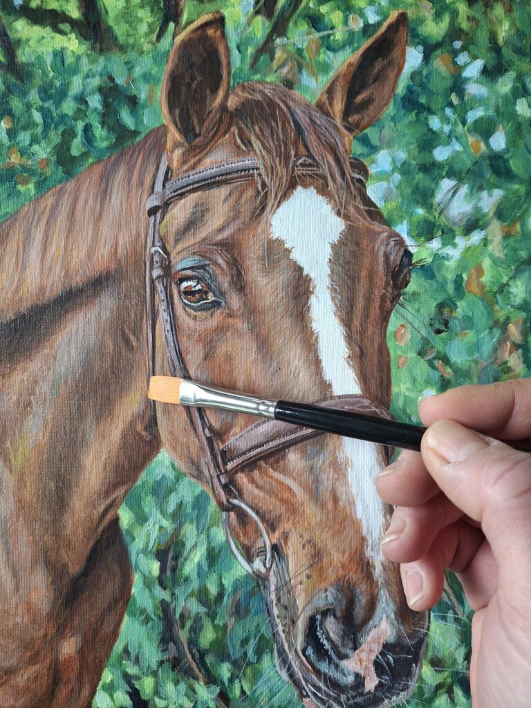 artist adding detail to a horse painting with a flat brush