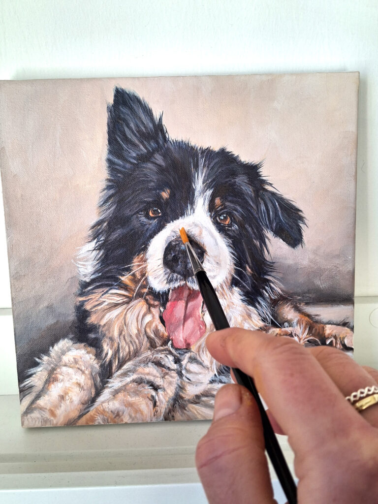 adding detail with a small round brush by artist hand