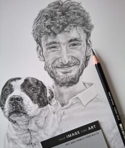 the finished drawing of a young man and his dog