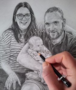 artist adding detail to a family pencil sketch with staedtler lumograph black pencil