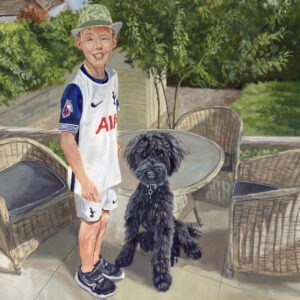 happy boy with puppy labradoodle dog in garden painting
