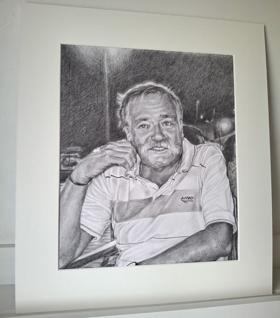 pencil portrait drawing in a mount in artist studio