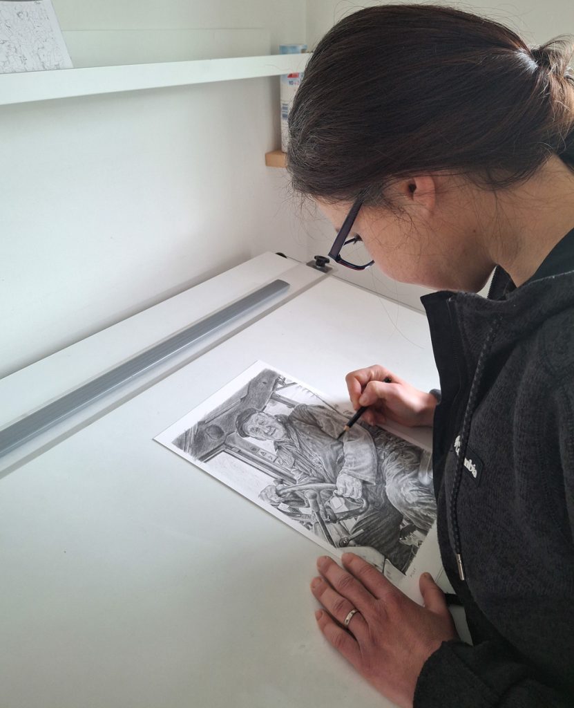 artist drawing a pencil portrait
