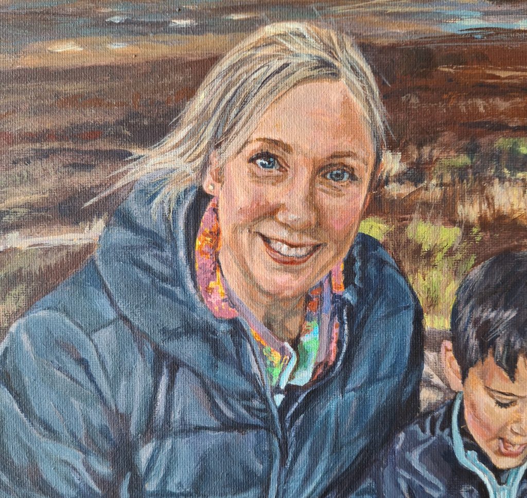 close up view of a smiling woman portrait painting on canvas